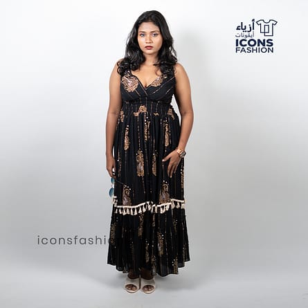 Black-sleeveless-maxi-dress-with-gold-paisley-prints-and-tassel-detailing-near-the-hem