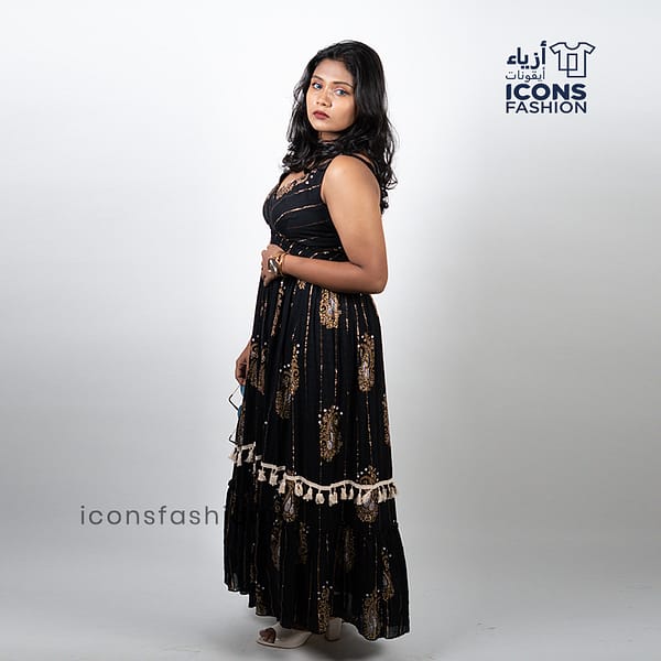 Black-sleeveless-maxi-dress-with-gold-paisley-prints-and-tassel-detailing-near-the-hem