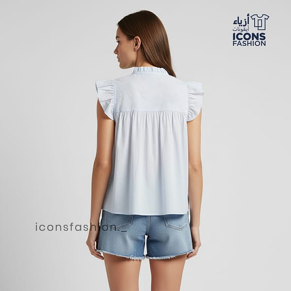 Pastel-blue-Aqaba-eyelet-embroidered-sleeveless-top-with-ruffle-sleeves-and-tie-up-neck