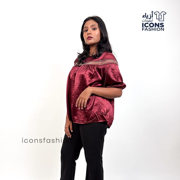 Wine-red-top-with-lace-detailing-across-the upper-chest-and-shoulders