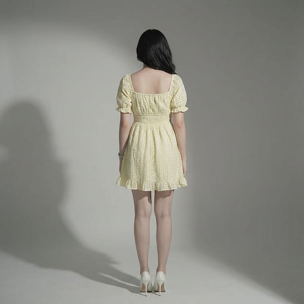 Women-yellow-eyelet-mini-dress-with-square-neck-puff-sleeves-smocked-waist-and-fit-and-flare-silhouette