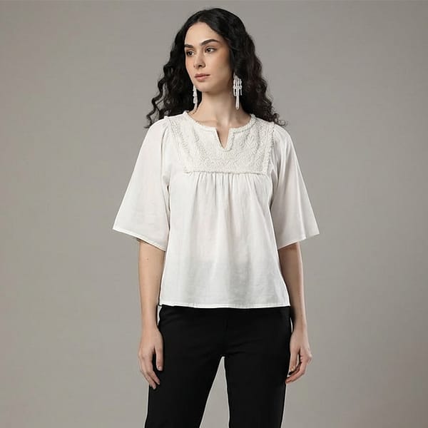 Women-off-white-embroidered-top-with-round-notch-neckline-elbow-length-flared-sleeves-with-fringe-trim-relaxed-fit-and-hip-length-straight-hem
